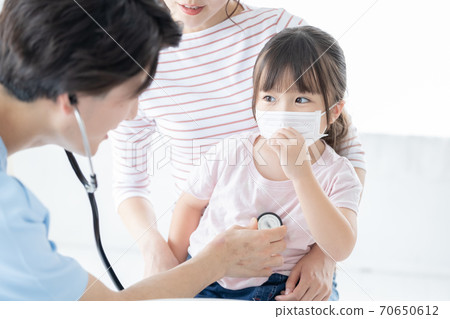 Girl undergoing medical examination 70650612