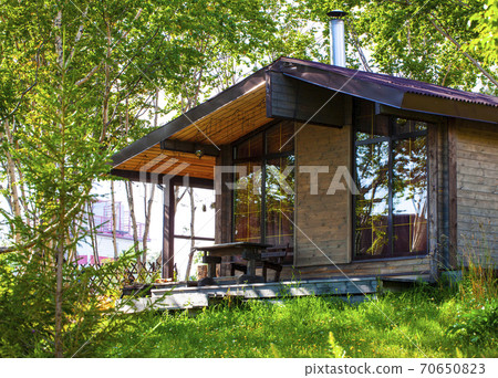 single-storey wooden house in the woods 70650823