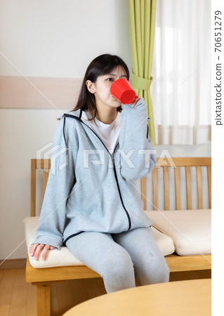 A woman who wakes up in the morning and drinks A woman who wakes up in the morning and drinks 70651279