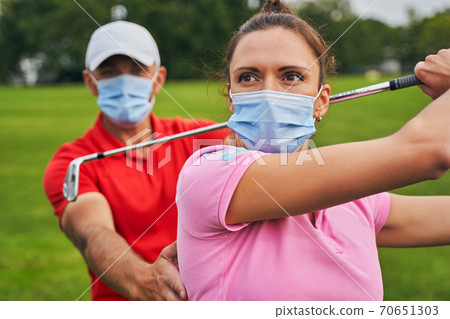 Woman with a club over her head staring away 70651303