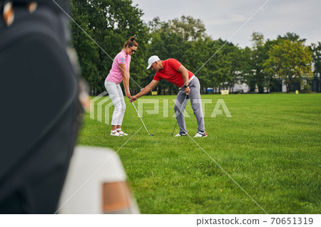 Experienced male tutor instructing a female beginner Experienced male tutor instructing a female beginner 70651319