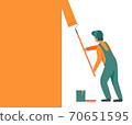 Man in overalls, working uniform with a roller paints, repaints the wall in orange color. 70651595