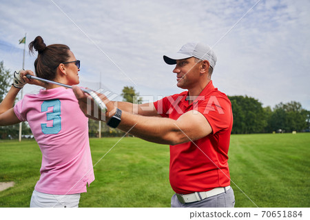 Female golfer learning to make a backswing 70651884