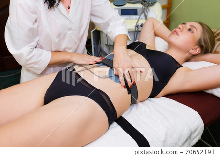 Anti-cellulite massage with modern technique of myostimulation of body muscles. 70652191