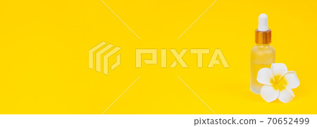 Banner for website cosmetic oil in dropper bottle on yellow background with place for text. 70652499