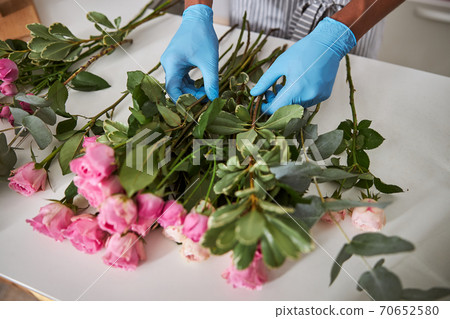 Male florist making flower composition for sale Male florist making flower composition for sale 70652580