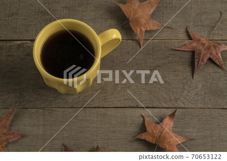 cup of coffee on a wooden table decorated dried autumn leaves 70653122