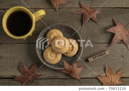 october template with coffee and cookies on wooden table decorated dried autumn leaves october template with coffee and cookies on wooden table decorated dried autumn leaves 70653126