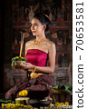 Thai girl in traditional dress costume making and decorating Krathong. Loy Krathong Festival. 70653581