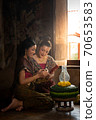 Two thai woman in traditional dress costume making and decorating Krathong. Loy Krathong Festival. 70653583