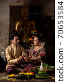 Thai couple in traditional dress costume making and decorating Krathong. Loy Krathong Festival. 70653584