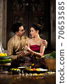 Thai couple in traditional dress costume making and decorating Krathong. Loy Krathong Festival. 70653585
