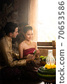 Thai couple in traditional dress costume making and decorating Krathong. Loy Krathong Festival. 70653586
