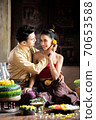 Thai couple in traditional dress costume making and decorating Krathong. Loy Krathong Festival. 70653588