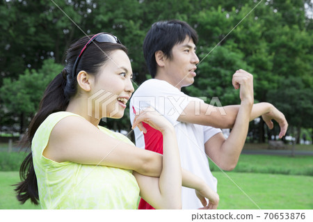 Men and women doing preparatory exercise Men and women doing preparatory exercise 70653876