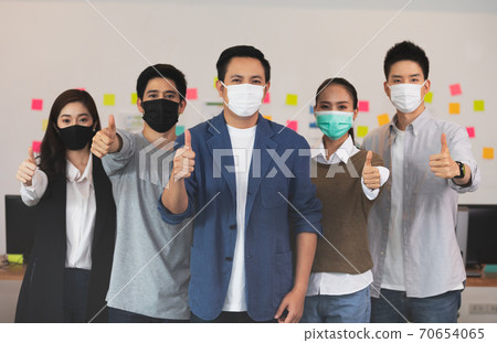 Group of Happy Asian business men leader standing making thumbs up with Business team at Co-Working space fight due COVID-19 virus pandemic,Small Business Startup Concept Group of Happy Asian business men leader standing making thumbs up with Business team at Co-Working space fight due COVID-19 virus pandemic,Small Business Startup Concept 70654065