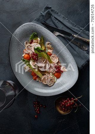 Close up on traditional italian cuisine Vitello tonnato. A dish with pickled veal with tuna cream sauce and bread on wooden background. Copy space for design, text. Snack before lunch. Close up food. 70654726