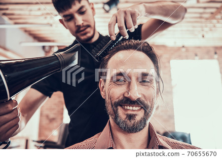 Hairdresser Dries Handsome Mans Hair. Barber Shop. 70655670