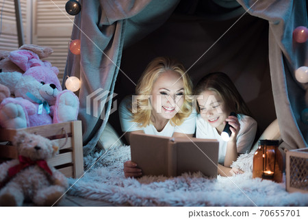 People are reading book in blanket house. People are reading book in blanket house. 70655701