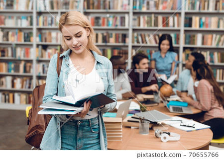 Group of ethnic multicultural students in library. Group of ethnic multicultural students in library. 70655766