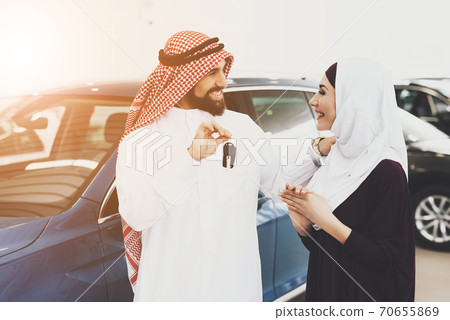 A man holds keys and smiles while makes a gift. A man holds keys and smiles while makes a gift. 70655869