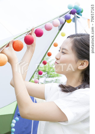 Woman decorating a tent 70657163