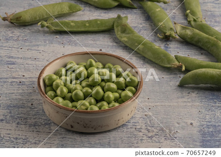 fresh raw peas on a wooden table fresh raw peas on a wooden table 70657249