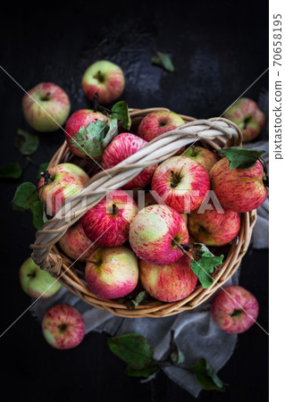 Fresh ripe autumn red apples in basket on rustic background 70658195