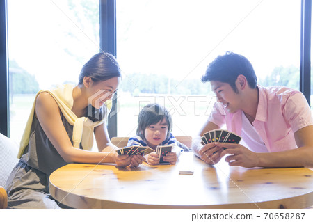 Parents and children playing with playing cards 70658287