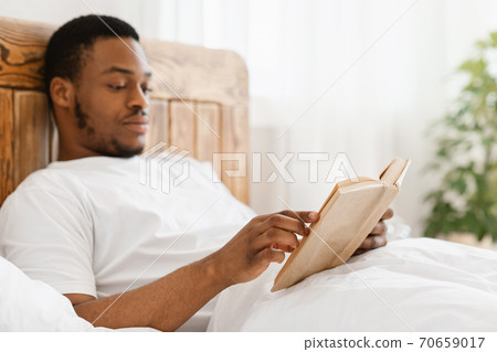 African American Man Reading Books Enjoying Morning Sitting In Bed African American Man Reading Books Enjoying Morning Sitting In Bed 70659017