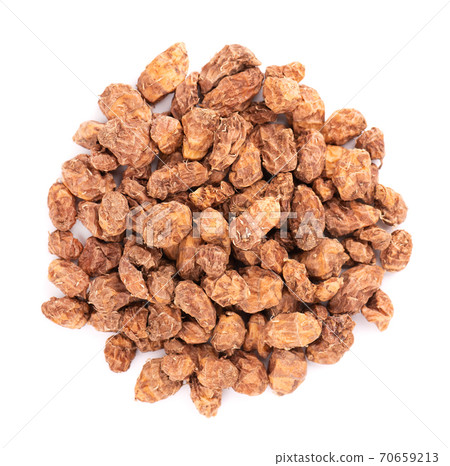 Tigernuts isolated on white background. Pile of chufa nuts or tiger nuts. Top view. Tigernuts isolated on white background. Pile of chufa nuts or tiger nuts. Top view. 70659213