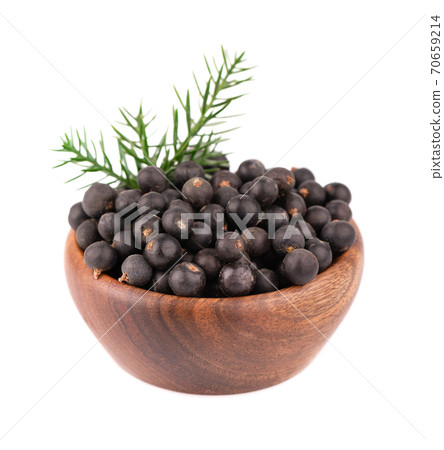 Dry juniper berries in wooden bowl, isolated on white background. Common Juniper fruits. Dry juniper berries in wooden bowl, isolated on white background. Common Juniper fruits. 70659214