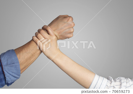 Social problems and protection of women. Male strong fist about to punch lady, woman stops man hand 70659273