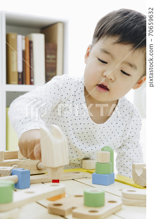 Infants playing with toys Infants playing with toys 70659632