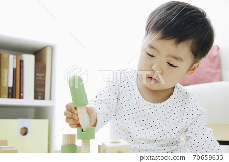 Infants playing with toys 70659633