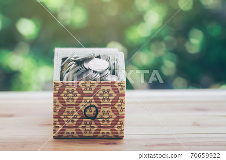 Coins in Treasure Chest indicate savings to buy a home and business growth. planning savings money of coins to buy a home concept for property, mortgage and real estate investment. saving for a house. Coins in Treasure Chest indicate savings to buy a home and business growth. planning savings money of coins to buy a home concept for property, mortgage and real estate investment. saving for a house. 70659922