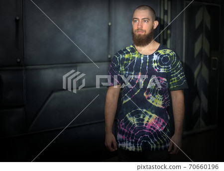 tie and die young man wearing t-shirt with printed design vivid colors fashion tie and die young man wearing t-shirt with printed design vivid colors fashion 70660196