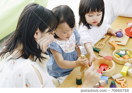 Parent and child playing with toys 70660788