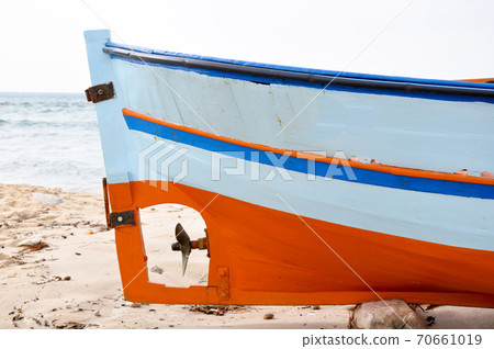 Hammamet, Tunisia- February 07, 2009: Tunisian Fishing boats on the beach with their traditional colors. Hammamet, Tunisia- February 07, 2009: Tunisian Fishing boats on the beach with their traditional colors. 70661019