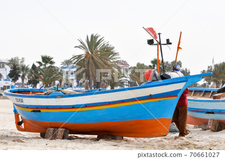 Hammamet, Tunisia- February 07, 2009: Tunisian Fishing boats on the beach with their traditional colors. 70661027