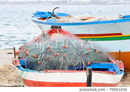 Hammamet, Tunisia- February 07, 2009: Tunisian Fishing boats on the beach with their traditional colors. 70661036