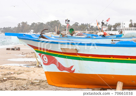 Hammamet, Tunisia- February 07, 2009: Tunisian Fishing boats on the beach with their traditional colors. 70661038