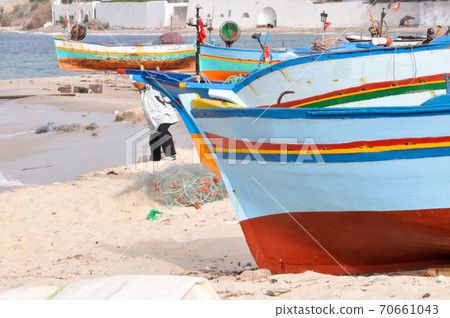 Hammamet, Tunisia- February 07, 2009: Tunisian Fishing boats on the beach with their traditional colors. 70661043
