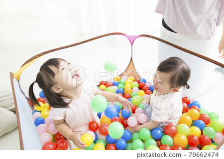 Infants playing in the ball pool 70662474