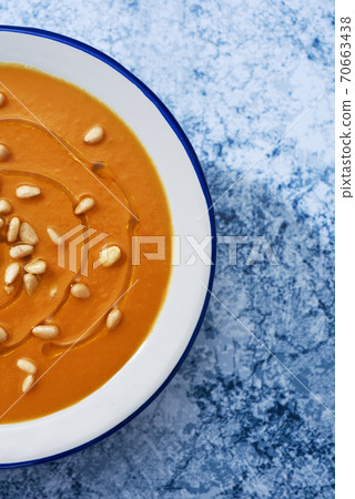pumpkin soup in a white enamel bowl 70663438