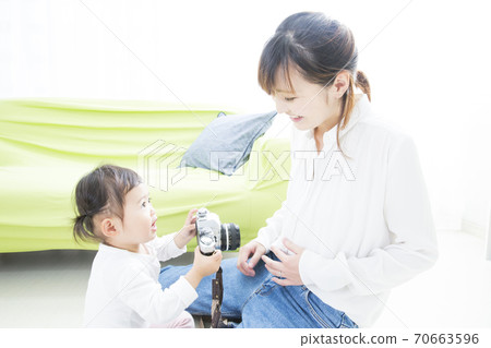 Parents and children playing with the camera Parents and children playing with the camera 70663596