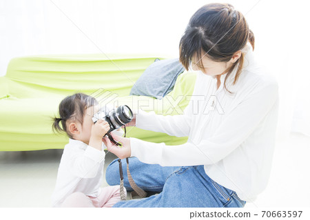 Parents and children playing with the camera Parents and children playing with the camera 70663597