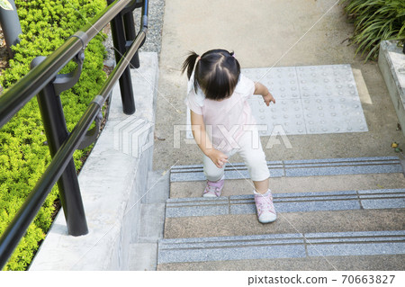 Girls climbing stairs 70663827