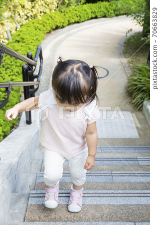 Girls climbing stairs 70663829