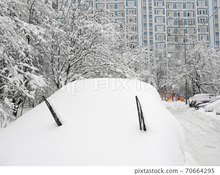 Winter, city courtyard, whole car under snow 70664295